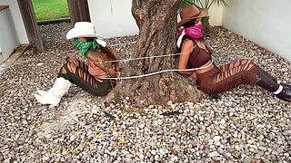 Crook Girls Tied Tight. Two Powerless Cowgirls Cleave Gagged to a Tree and Rough Ropes Hogtie