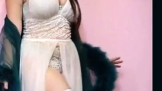 Busty Brunette's Sensual Striptease in BDSM-themed Lingerie
