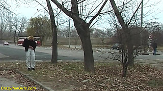 Young girl pissing on street