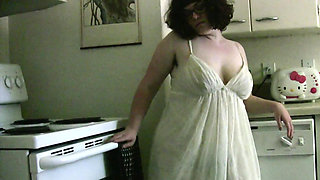 MILF Bianca Dagger with natural tits caresses herself in the kitchen