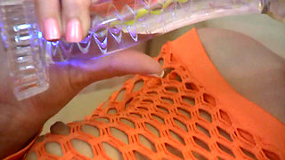 Babe in fishnet outfit rips pantyhose and puts a dildo in her shaved cunt