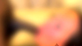 In a kitchen a sexy brunette playing with her big boobs