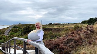 Blonde is flashing her big boobs in the outdoors