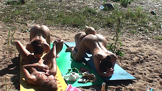 Four Tanned Stepsisters Lick Their Pussies in the Sun on the Beach